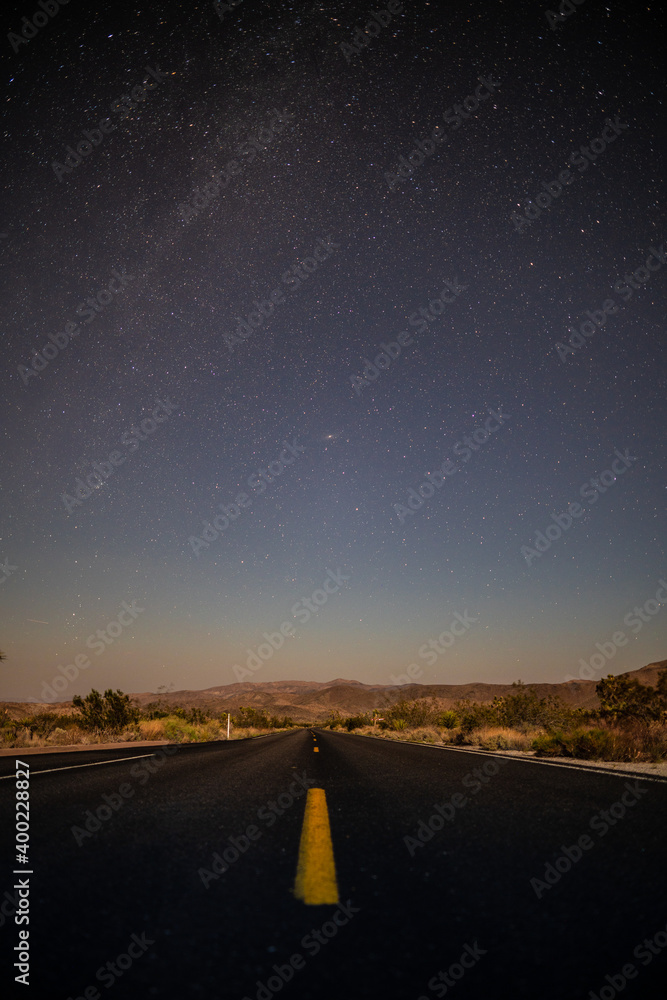 American desert road at night with stars