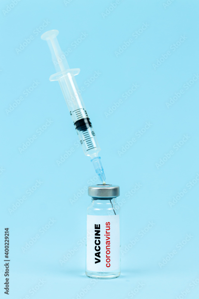 Concept of vaccine against coronavirus COVID-19. Glass vial for liquid vaccine sample with syringe Concept of vaccine against coronavirus COVID-19. Glass vial for liquid vaccine sample with syringe
