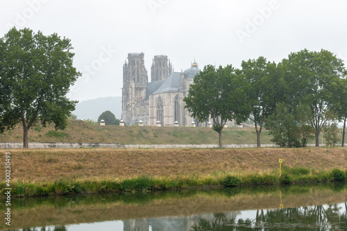 Cathedral of Toul in a misty atmosphere with the Moselle river in front