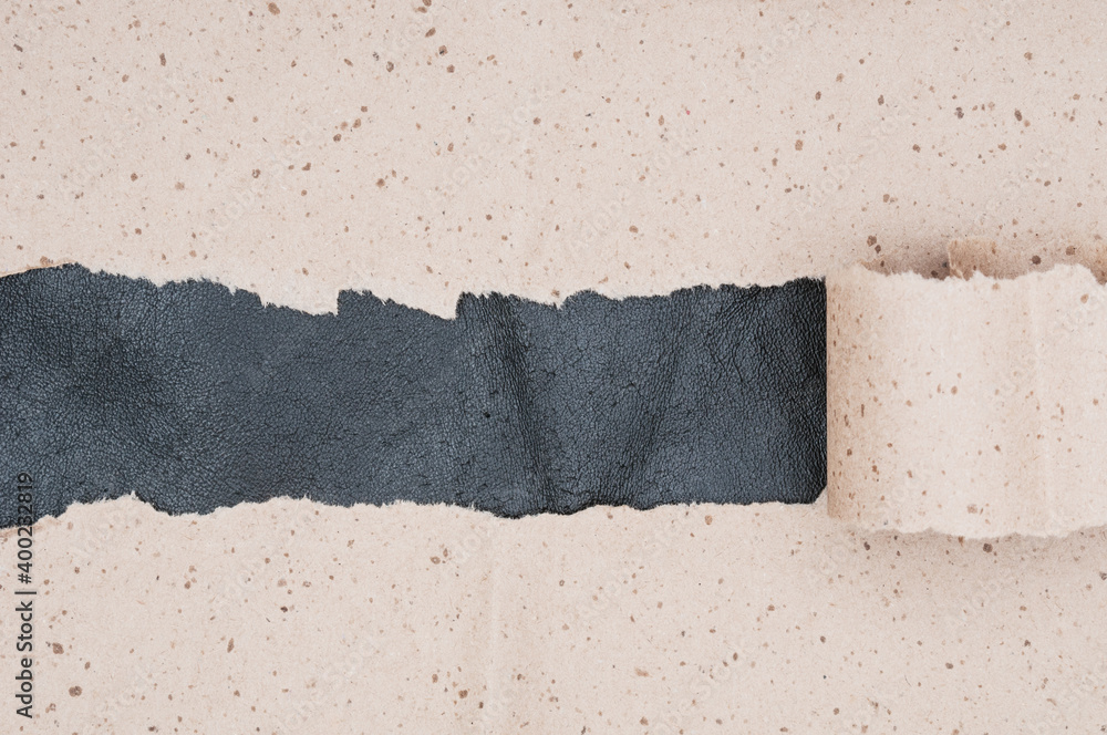 Torn crumpled paper on leather material background Torn crumpled paper on leather material background