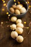 beautiful whole walnuts are scattered on a wooden table and decorated with garlands
