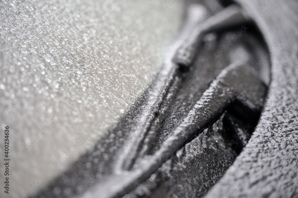 Shallow depth of field with detail of a frozen car windscreen and wipers after freezing rain phenomenon Shallow depth of field with detail of a frozen car windscreen and wipers after freezing rain phenomenon
