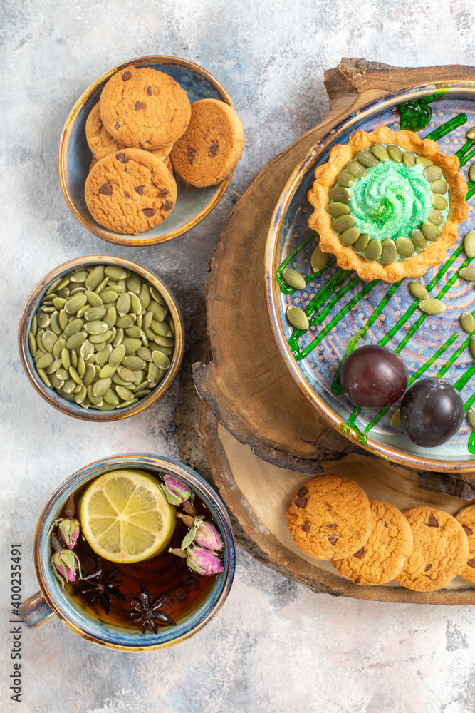 top view little cake with fruits and tea on a light background photo biscuit candy sweet