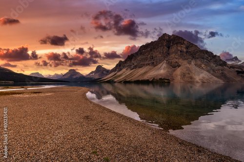 Beautiful Canadian Nature landscape view of Bow Lake in Banff National Park, Alberta, Canada. Dramatic Colorful Sunrise Sky. Scenic Background