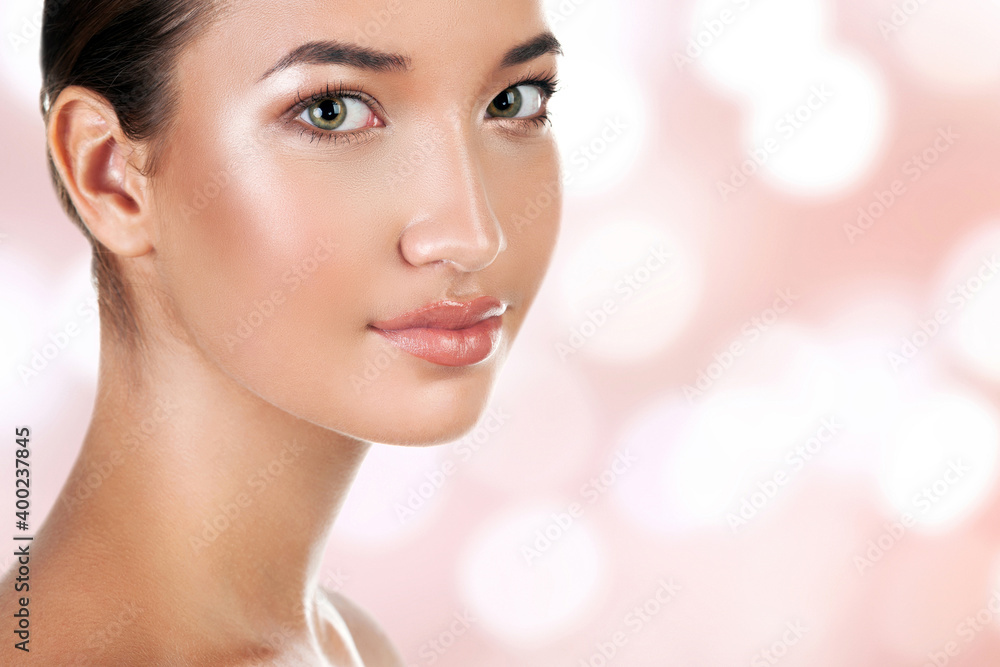 Portrait of pretty woman against an abstract background with blurred lights. Skin care concept Portrait of pretty woman against an abstract background with blurred lights. Skin care concept