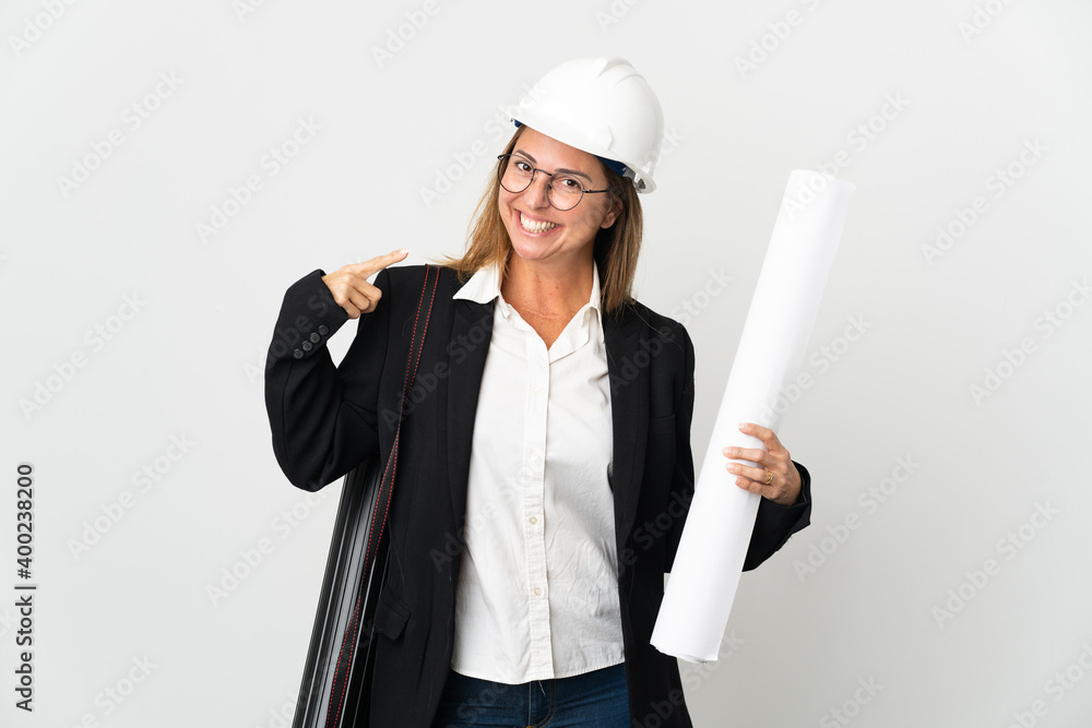 Middle age architect woman with helmet and holding blueprints over isolated background giving a thumbs up gesture Middle age architect woman with helmet and holding blueprints over isolated background giving a thumbs up gesture