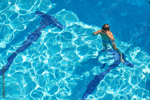 Kid in the swimming pool view from above