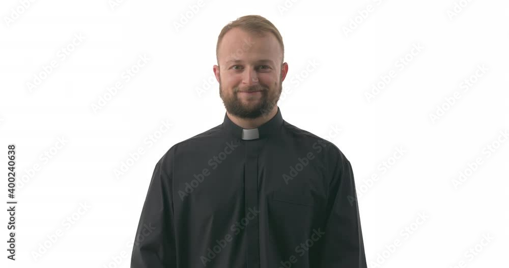 Young Caucasian priest takes off medical face mask and smiling looking at camera. Health care concept. Isolated on white background Young Caucasian priest takes off medical face mask and smiling looking at camera. Health care concept. Isolated on white background