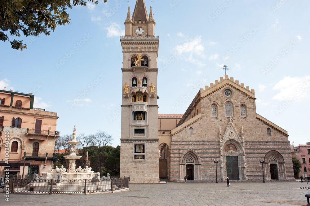 Square of the cathedral with the majestic basilica, the belfry with the astronomical clock,  and the monumental fountain of Orion made by a pupil of Michelangelo in 1553. Messina,  Sicily, Italy.
