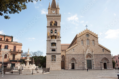 Square of the cathedral with the majestic basilica, the belfry with the astronomical clock, and the monumental fountain of Orion made by a pupil of Michelangelo in 1553. Messina, Sicily, Italy.