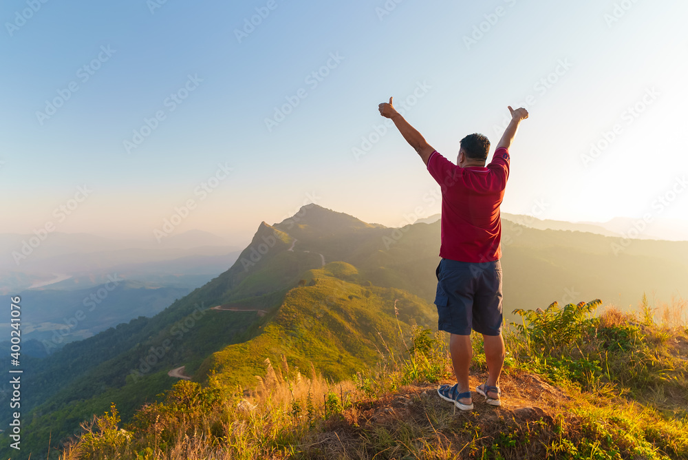 Senior retired man raise hand after success climbed mountain Senior retired man raise hand after success climbed mountain