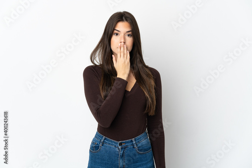 Teenager Brazilian girl isolated on white background covering mouth with hand