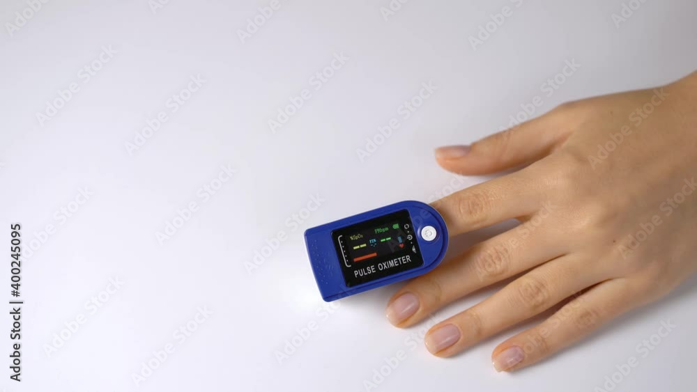 Close-up on a finger, putting on a pulse oximeter to check the pulse of the amount of oxygen in the blood. White background. Diagnosis of a patient by a doctor. Close-up on a finger, putting on a pulse oximeter to check the pulse of the amount of oxygen in the blood. White background. Diagnosis of a patient by a doctor.