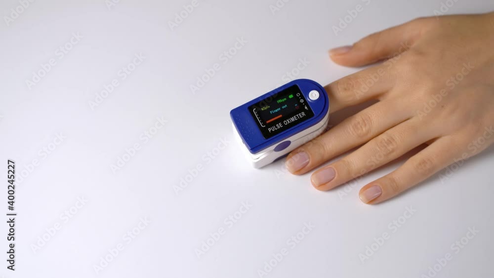 Close-up on a finger, putting on a pulse oximeter to check the pulse of the amount of oxygen in the blood. White background. Diagnosis of a patient by a doctor. Close-up on a finger, putting on a pulse oximeter to check the pulse of the amount of oxygen in the blood. White background. Diagnosis of a patient by a doctor.