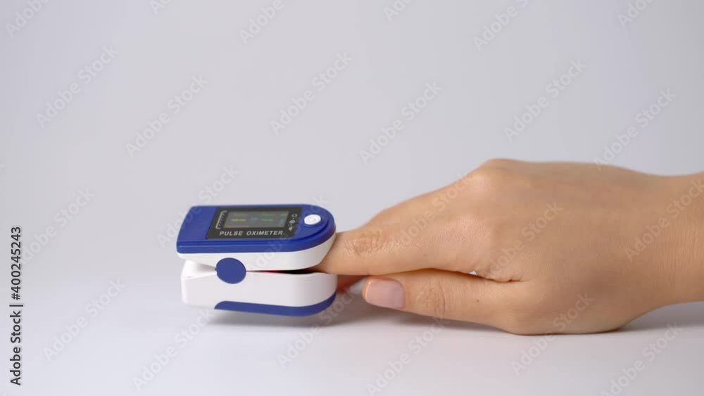 Close-up on a finger, putting on a pulse oximeter to check the pulse of the amount of oxygen in the blood. White background. Diagnosis of a patient by a doctor. Close-up on a finger, putting on a pulse oximeter to check the pulse of the amount of oxygen in the blood. White background. Diagnosis of a patient by a doctor.