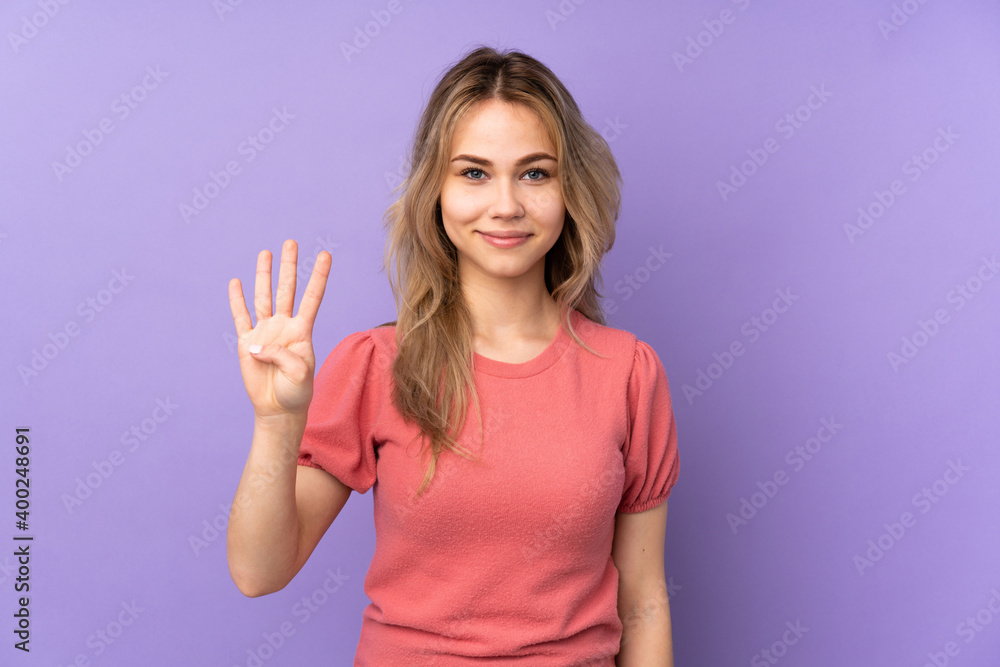 Teenager Russian girl isolated on purple background happy and counting four with fingers Teenager Russian girl isolated on purple background happy and counting four with fingers