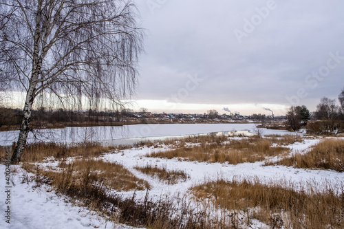 Urban landscape with the river Uvod and birch on an autumn day in the city of Ivanovo.