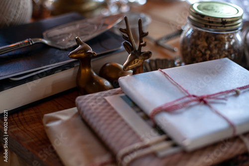 Hand crafted gift, glass bottles, deer figurines on rustic wooden background © Dana Keli