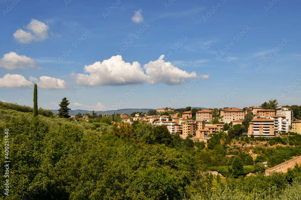 Scenic view of a residential area on the hills adjacent to the historic center of Siena in a sunny summer day, Tuscany, Italy