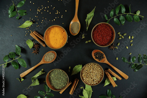 Obraz na płótnie Wide variety spices and herbs on background of black table
