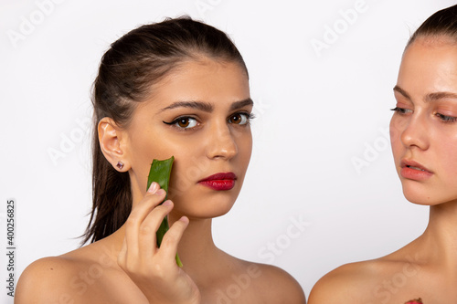 Spa and beauty concept. Enlarged photo of young girls with aloe vera mask. Isolated on white.