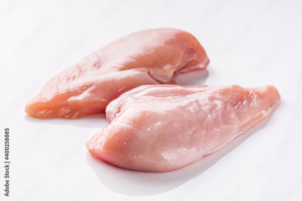 raw chicken fillet on a white acrylic background raw chicken fillet on a white acrylic background