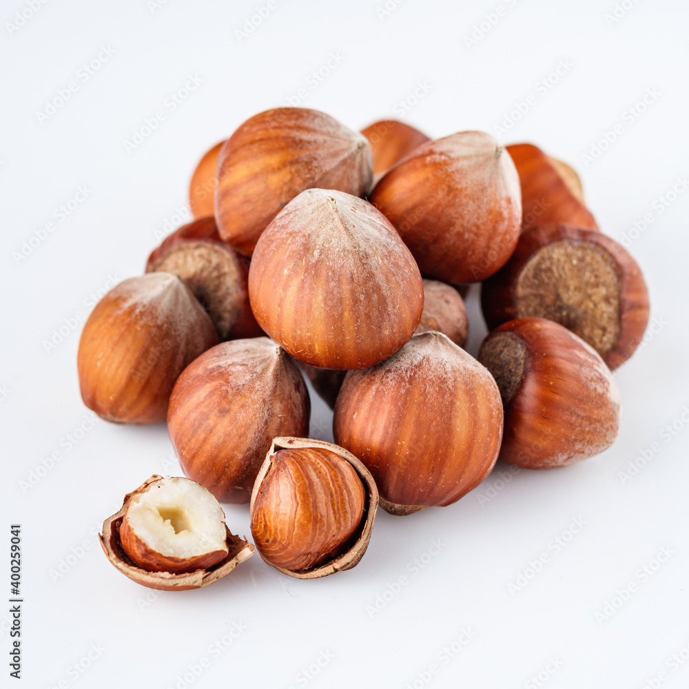 fresh natural hazelnuts on a white acrylic background fresh natural hazelnuts on a white acrylic background