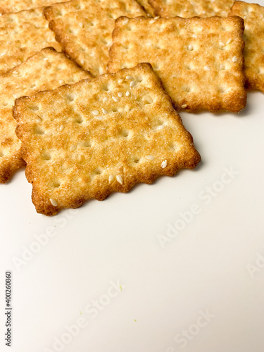 cookies with sugar sprinkles and sesame seeds on a white table