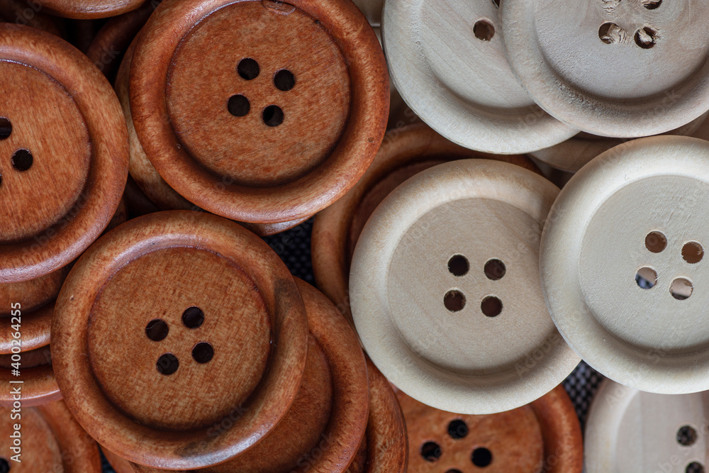 Group of round wooden sewing buttons. Brown and natural wooden sewing buttons. Close up. Macro. Group of round wooden sewing buttons. Brown and natural wooden sewing buttons. Close up. Macro.