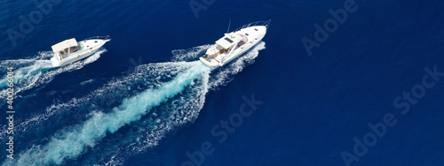 Aerial drone ultra wide photo of speed boat cruising fast in deep blue Aegean Sea © aerial-drone