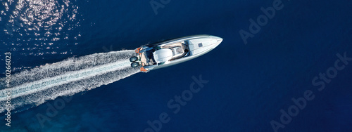 Aerial drone ultra wide photo of speed boat cruising fast in deep blue Aegean Sea