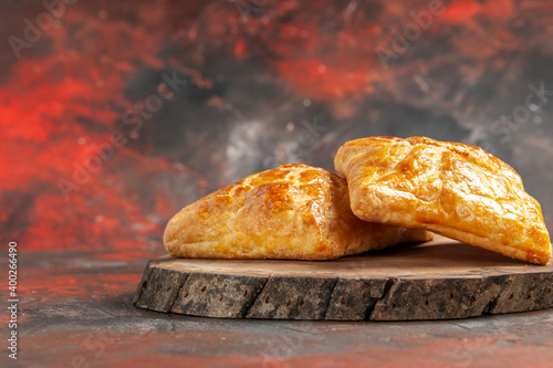 front view penovani khachapuri on wood board on dark red background free place photo