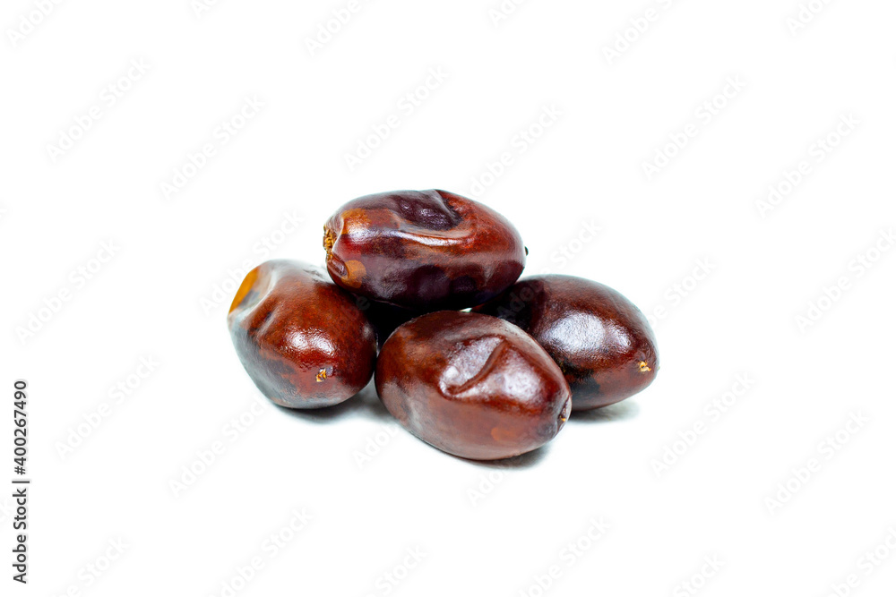 Sweet dried brown dates heap isolated on white background. Sweet dried brown dates heap isolated on white background.