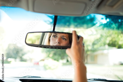 Wallpaper Mural Woman adjusting rear-view mirror in car Torontodigital.ca