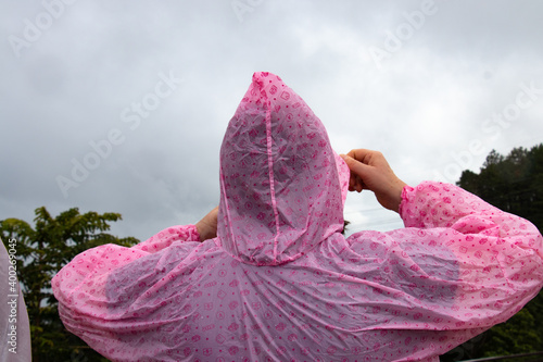 Tableau sur toile person wearing pink rain poncho in the rainy mountains of Northern Thailand - cl