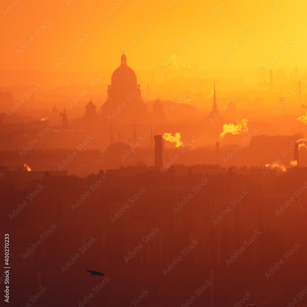Obraz premium Aerial panoramic view of Saint-Petersburg, Russia, with St. Isaac's cathedral, the Winter Palace and Admiralty, with beautiful vibrant red orange sunset sundown, dusk cityscape silhouette scenery