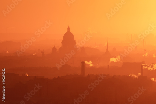 Aerial panoramic view of Saint-Petersburg, Russia, with St. Isaac's cathedral, the Winter Palace and Admiralty, with beautiful vibrant red orange sunset sundown, dusk cityscape silhouette scenery