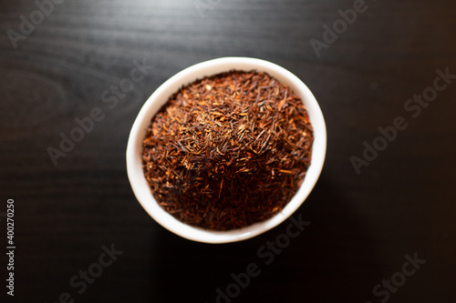 Rooibos tea on white plate on a wooden table