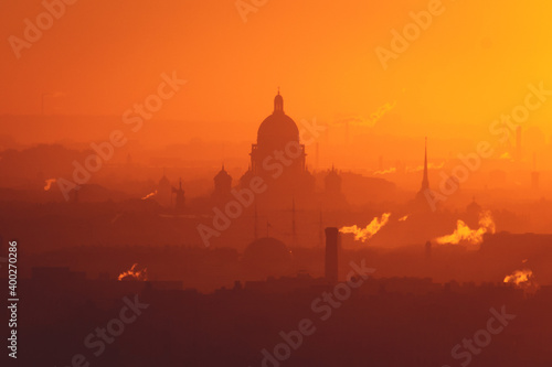 Aerial panoramic view of Saint-Petersburg, Russia, with St. Isaac's cathedral, the Winter Palace and Admiralty, with beautiful vibrant red orange sunset sundown, dusk cityscape silhouette scenery