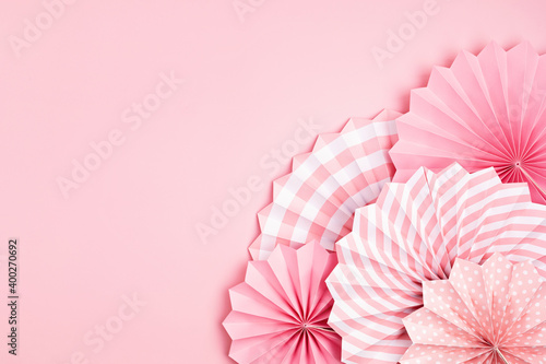 Festive party background with pink paper circle fans over pastel background. Festival  birthday  baby shower decoration