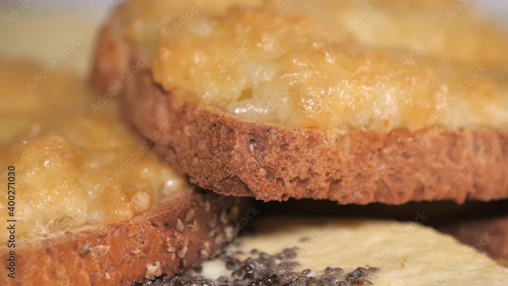 The closer look of the toasted bread with butter on top in the plate.close-up.4K UHD The closer look of the toasted bread with butter on top in the plate.close-up.4K UHD