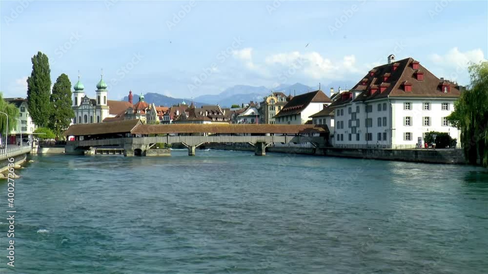 Spreuer Bridge over the Reuss River in Luzern, Lucerne, Switzerland. Jesuit Church in the background. Spreuer Bridge over the Reuss River in Luzern, Lucerne, Switzerland. Jesuit Church in the background.