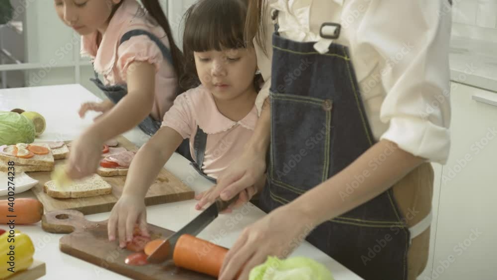 The little girl helped her mother cook in the kitchen. The little girl helped her mother cook in the kitchen.
