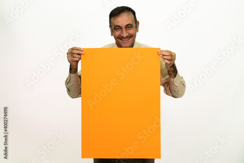 Man holding billboard in his hand. The man is dressed in a white shirt and fabric pants. Isolated image on white background.