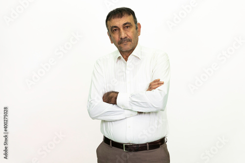 Man wearing a white shirt and fabric pants. Isolated image white background. © Alaka Film