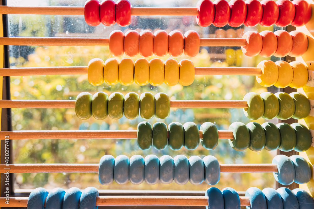 Detail of the colored beads of a wooden abacus, elementary educational material. Detail of the colored beads of a wooden abacus, elementary educational material.