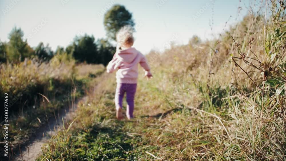 Parents and baby playing catch-up run. Baby child fun running in green meadow. Happy family kid dream concept. Parents and baby playing catch-up run. Baby child fun running in green meadow. Happy family kid dream concept.