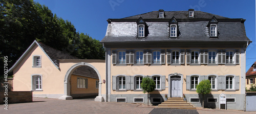 Facade of a baroque town palace with mansard roof and court gate in the old town of Meisenheim
in Germany