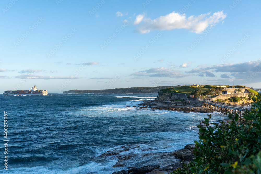 view of  the sea, as a cargo ship goes by at La Perouse, Sydney Australia