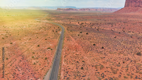 Countryside road through the fabulous Monument Valley in summser season, aerial view from drone